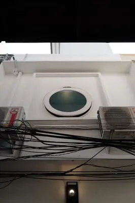 a ceiling with a green and white clock on it at Marlowe-Tony's home in Bangkok