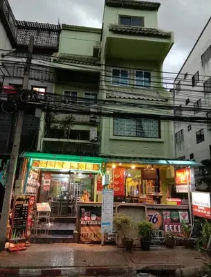 a store in front of a building with a building at Swan inn 2 Nana in Bangkok