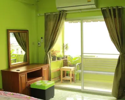 a bedroom with a mirror and a dresser and a mirror at Swan inn 2 Nana in Bangkok