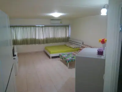 a room with a bed and a couch in it at Impact Don Mueang Bangkok Guest House For 3 Pax in Nonthaburi