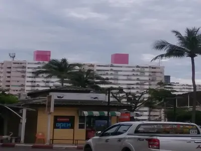 a car parked in front of a gas station with tall buildings at Impact Don Mueang Bangkok Guest House For 3 Pax in Nonthaburi