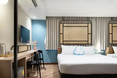 a hotel room with a bed and a desk at The Cotton Saladaeng Hotel in Bangkok
