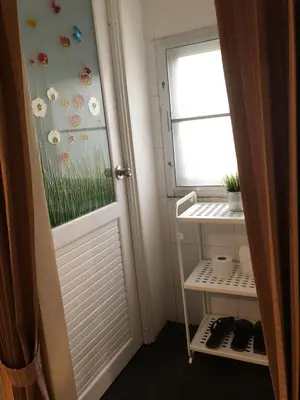 a room with a door and a window and a shelf at VX The Fifty in Bangkok