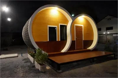 a circular house with a bench in front of it at Tiny hut resort in Bangkok
