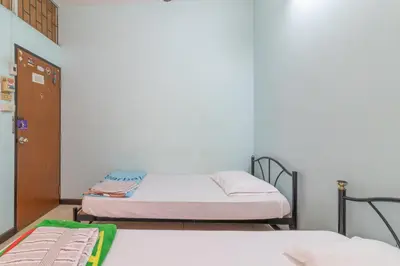 a room with two beds in a room at 7 Holder Guesthouse in Bangkok