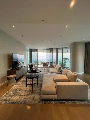 a large living room with a couch and a tv at Magnolias Ratchadamri Boulevard Serviced Residences in Bangkok