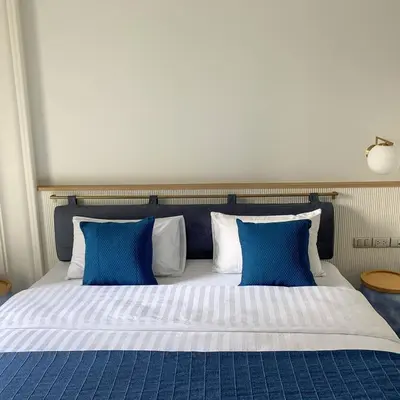 a large bed with blue and white pillows at Blu 395 in Bangkok