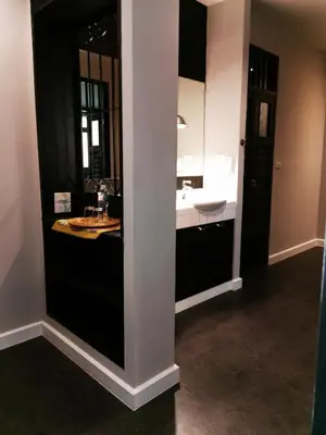 a bathroom with black cabinets and a sink at Chomm House in Bangkok