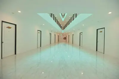 an empty hallway with doors and a ceiling at Parvena Ratchada in Bangkok
