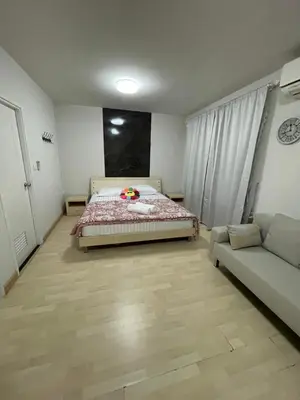 a bedroom with a bed and a couch in it at M Villa @ Impact Muangthongthani in Ban Bang Phang