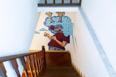 a mural on the side of a stairway at Taladnoi Paint House in Bangkok