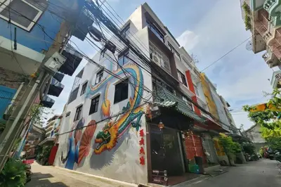 a building with a painting on the side of it at Taladnoi Paint House in Bangkok