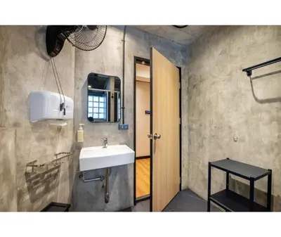 a bathroom with a sink and a mirror at Siam Subway Hostel and Café in Bangkok