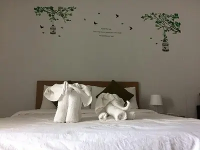 two stuffed animals sitting on top of a bed at ruamsab apartment1 in Bangkok