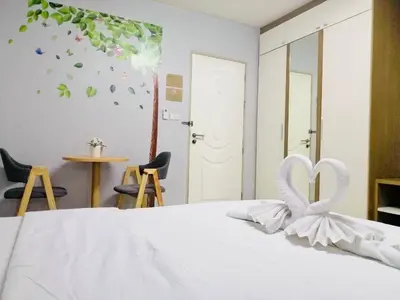 a white bed with a heart decoration on it at ruamsab apartment1 in Bangkok