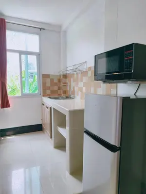 a kitchen with a white refrigerator and a window at Cloud no 3 Serene Oasis King Bed in BKK Heart in Bangkok