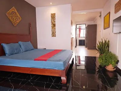 a bedroom with a bed with blue and red sheets at Old Spice 4 Downtown Serenity Luxurious Oasis BKK in Bangkok