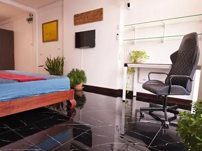 a bedroom with a bed and a desk and a chair at Old Spice 4 Downtown Serenity Luxurious Oasis BKK in Bangkok