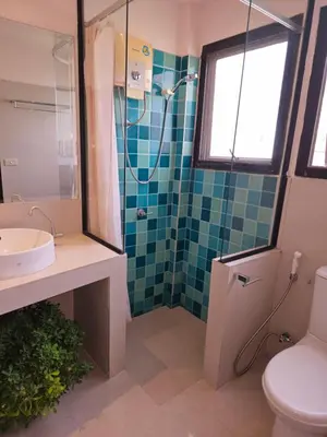 a bathroom with a shower and a toilet and a sink at Old Spice 4 Downtown Serenity Luxurious Oasis BKK in Bangkok