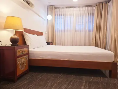 a bedroom with a bed with a lamp and a window at Old Sрice 2 Urban Studio Oasis Central Bangkok MRT in Bangkok