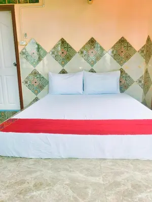 a bedroom with a white bed with a red blanket at Sky bedroom with a smooth life view in Bangkok
