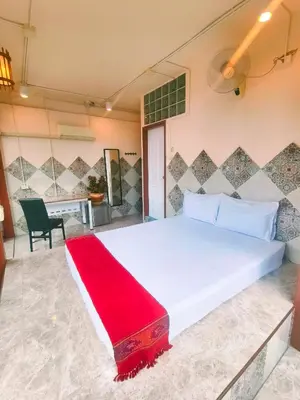 a bedroom with a large white bed and a chair at Sky bedroom with a smooth life view in Bangkok