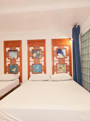 a bedroom with two beds and blue curtains at Old Sрice 1 Sizzling Studio Queen Twin - No Stairs in Bangkok
