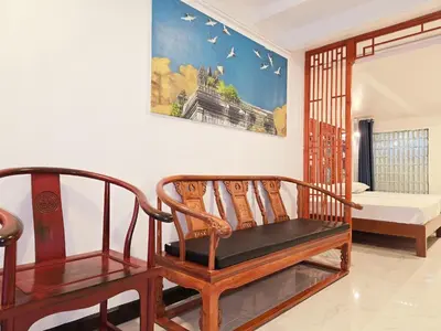 a living room with two chairs and a bed at Old Sрice 1 Sizzling Studio Queen Twin - No Stairs in Bangkok