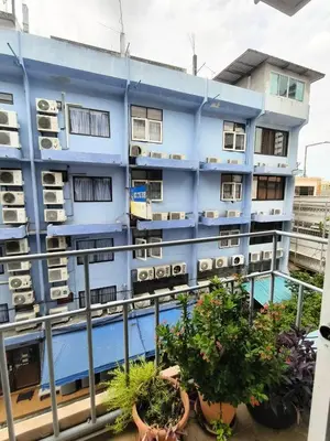 a blue building with potted plants on a balcony at Cloud no 4 Green n Quiet Heart BKK With a Balcony in Bangkok