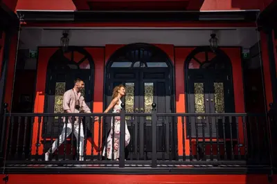 a man and a woman walking on a balcony at DE Phanakron Boutique Hotel in Bangkok