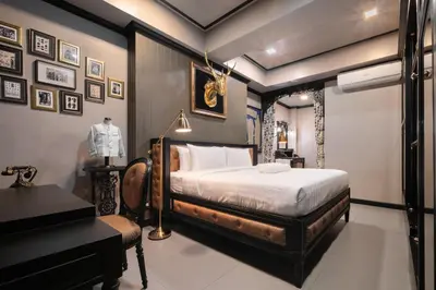 a bedroom with a bed and a piano at DE Phanakron Boutique Hotel in Bangkok