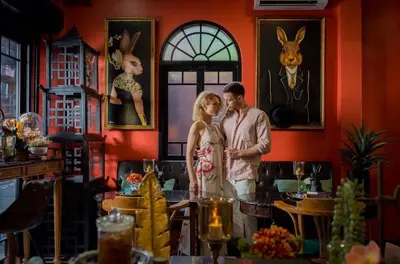 a man and a woman standing in a room at DE Phanakron Boutique Hotel in Bangkok