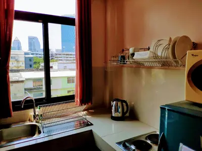 a kitchen with a sink and a window with a view at Old Sрice 5 Elegant Tranquility Your BKK Haven in Bangkok