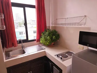 a small kitchen with a sink and a window at Old Sрice 5 Elegant Tranquility Your BKK Haven in Bangkok