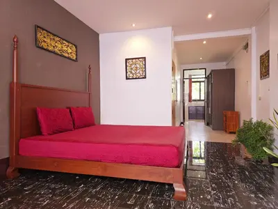 a bedroom with a bed with a red blanket at Old Sрice 3 Vintage Elegance in the Heart of BKK in Bangkok