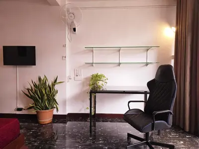 an office with a desk and a chair and a fan at Old Sрice 3 Vintage Elegance in the Heart of BKK in Bangkok