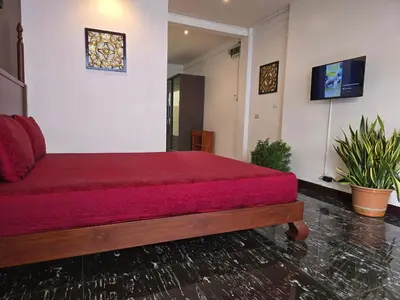 a bedroom with a large bed with a red blanket at Old Sрice 3 Vintage Elegance in the Heart of BKK in Bangkok