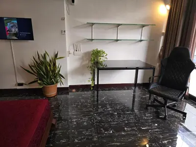 a room with a table and two chairs and plants at Old Sрice 3 Vintage Elegance in the Heart of BKK in Bangkok