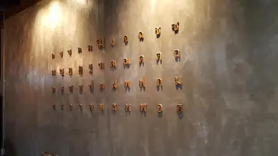a wall with a bunch of ancient objects on it at baankorrakang in Bangkok Noi