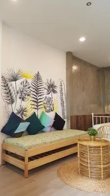 a bed with pillows on it in a room at baankorrakang in Bangkok Noi