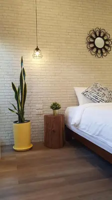 a bedroom with a bed and a potted plant at baankorrakang in Bangkok Noi