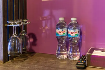 three bottles of water sitting on top of a table at BB Glass House บีบี กลาสเฮ้าส์ in Bangkok