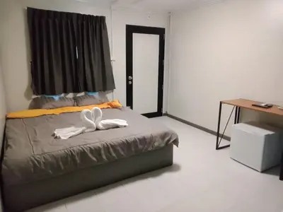 a bedroom with a bed with two white towels on it at P29 in Bangkok