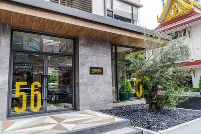 a store front with a tree in front of it at 56 Surawong Hotel Bangkok in Bangkok