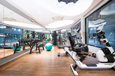 a gym with treadmills and elliptical machines at S Ratchada Leisure Hotel in Bangkok
