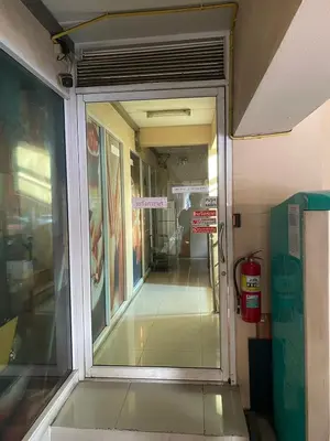 an entrance to a building with a glass door at Ladapan Mansion in Nonthaburi