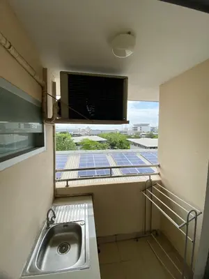 a small bathroom with a sink and a window at Ladapan Mansion in Nonthaburi