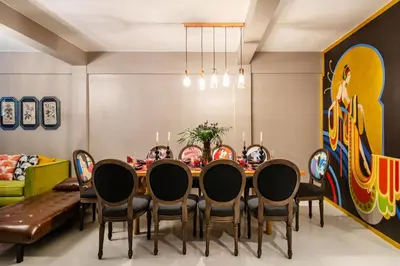 a dining room with a table and chairs at The Mellow at Silom in Bangkok
