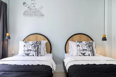 two beds sitting next to each other in a bedroom at The Mellow at Thong Lo in Bangkok