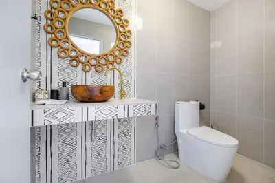 a bathroom with a sink and a mirror and a toilet at The Mellow at Thong Lo in Bangkok